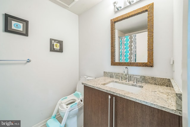 full bathroom with vanity, toilet, and visible vents