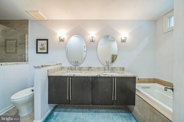 full bathroom with a sink, a garden tub, a stall shower, and double vanity