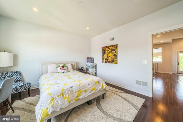 bedroom featuring baseboards, visible vents, and dark wood finished floors