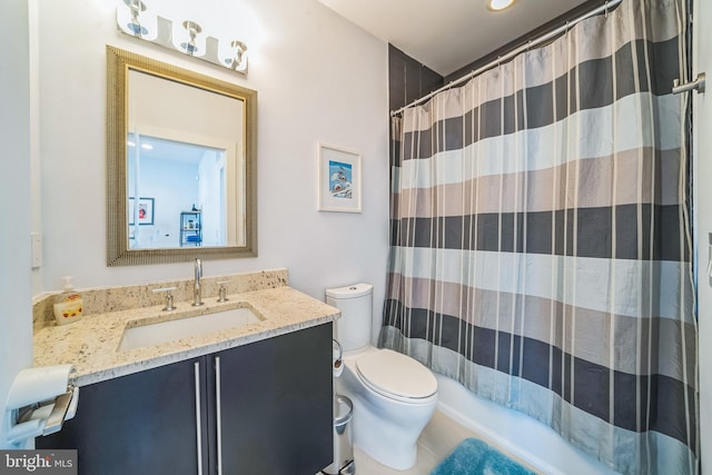 bathroom featuring vanity, curtained shower, and toilet