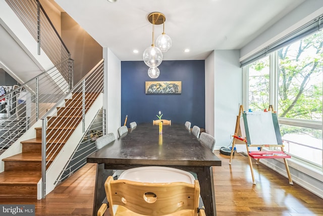 dining area with recessed lighting, wood finished floors, and stairway