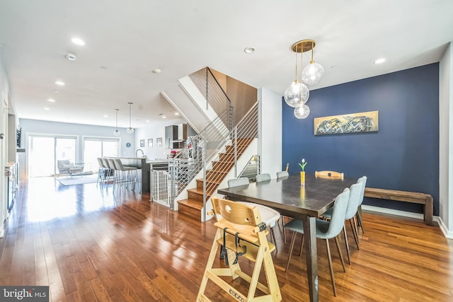 dining space with stairway, baseboards, recessed lighting, and hardwood / wood-style floors
