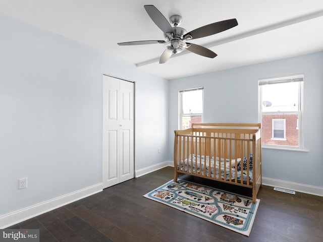 bedroom with visible vents, baseboards, and wood finished floors