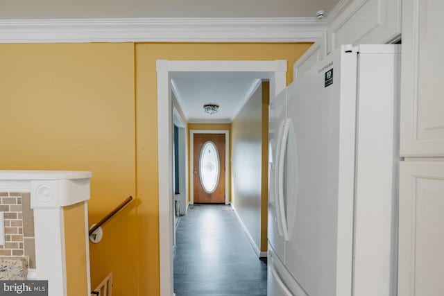 hall with ornamental molding and wood finished floors