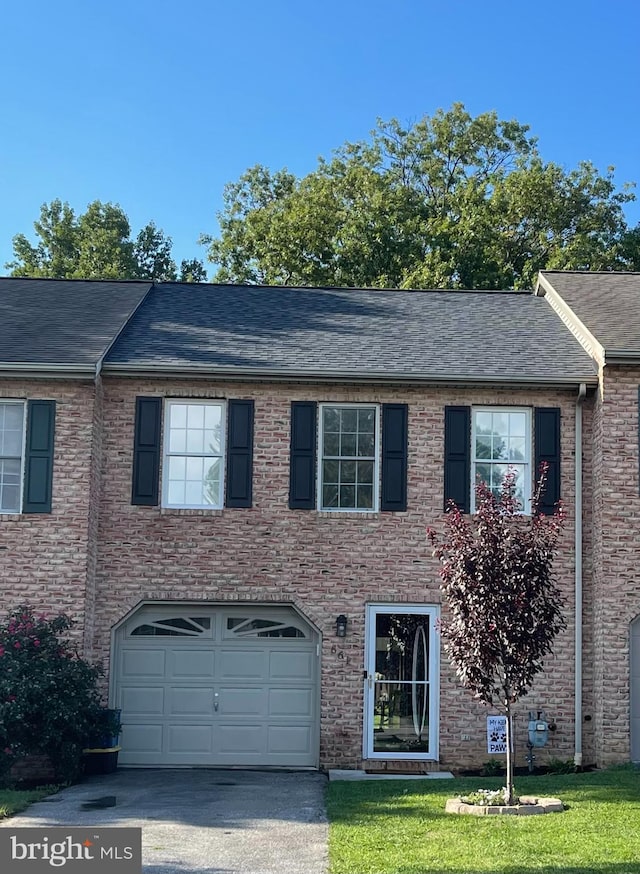 661 Hartman Ave, Hanover, PA 17331 - view of front of property featuring a front yard, roof with shingles, a garage, brick siding, and aphalt driveway