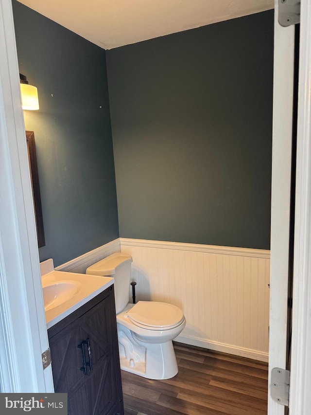661 Hartman Ave, Hanover, PA 17331 - half bath with vanity, wainscoting, wood finished floors, and toilet