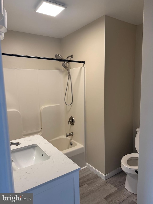 661 Hartman Ave, Hanover, PA 17331 - bathroom with vanity, toilet, baseboards, shower / washtub combination, and wood finished floors