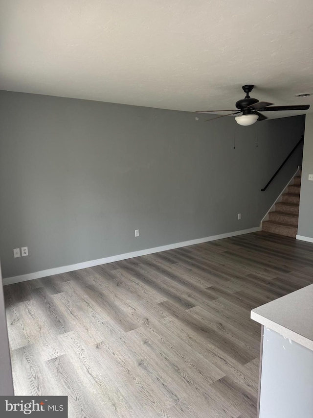 661 Hartman Ave, Hanover, PA 17331 - unfurnished living room featuring stairway, baseboards, ceiling fan, and wood finished floors