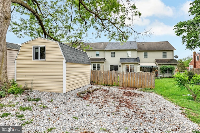 661 Hartman Ave, Hanover, PA 17331 - rear view of house with an outdoor structure, a gambrel roof, a shed, fence private yard, and a lawn