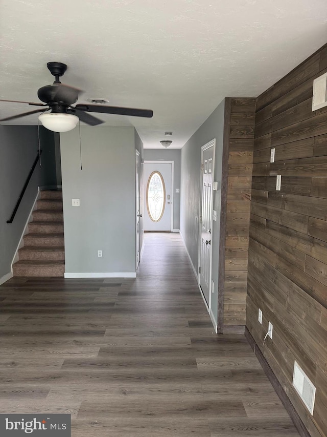 661 Hartman Ave, Hanover, PA 17331 - entrance foyer with wooden walls, a ceiling fan, baseboards, wood finished floors, and visible vents