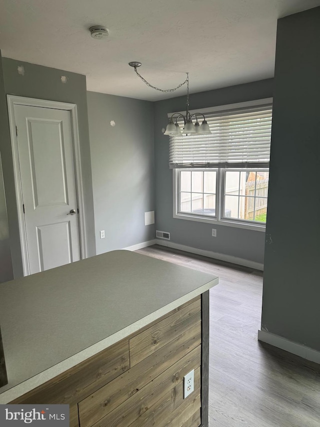661 Hartman Ave, Hanover, PA 17331 - unfurnished dining area with baseboards, wood finished floors, and visible vents