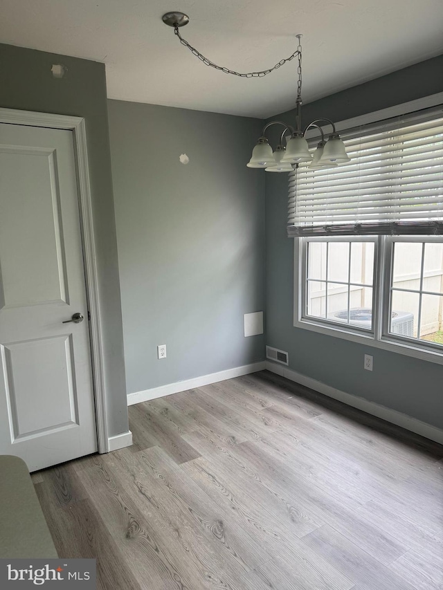 661 Hartman Ave, Hanover, PA 17331 - unfurnished dining area featuring an inviting chandelier, visible vents, wood finished floors, and baseboards