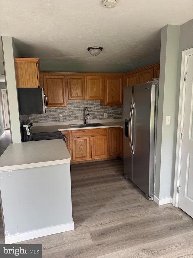 661 Hartman Ave, Hanover, PA 17331 - kitchen with a sink, light countertops, light wood-style flooring, stainless steel appliances, and backsplash