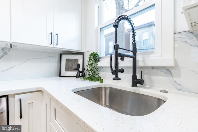 2074 E Birch St, Philadelphia, PA 19134 - room details featuring white cabinets, light stone counters, decorative backsplash, and a sink
