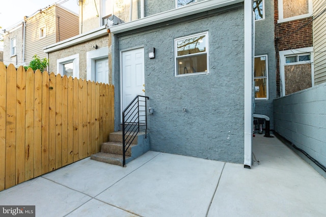2074 E Birch St, Philadelphia, PA 19134 - exterior space featuring stucco siding, a patio area, and fence
