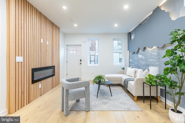 2074 E Birch St, Philadelphia, PA 19134 - living room with wood walls, a glass covered fireplace, an accent wall, recessed lighting, and wood finished floors