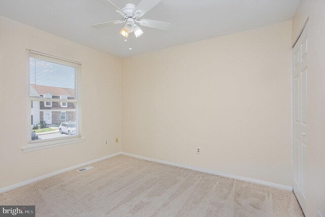 unfurnished room featuring baseboards, carpet, ceiling fan, and visible vents