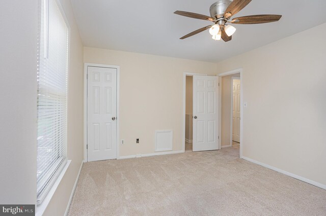 unfurnished bedroom with a ceiling fan, baseboards, and carpet