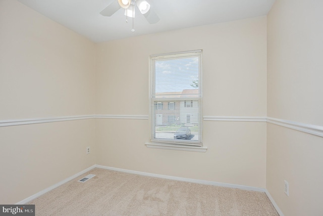 unfurnished room with baseboards, visible vents, a healthy amount of sunlight, and carpet