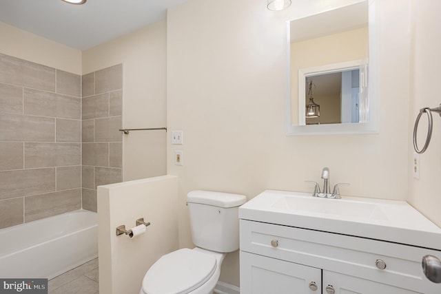 bathroom featuring vanity, tile patterned floors, and toilet