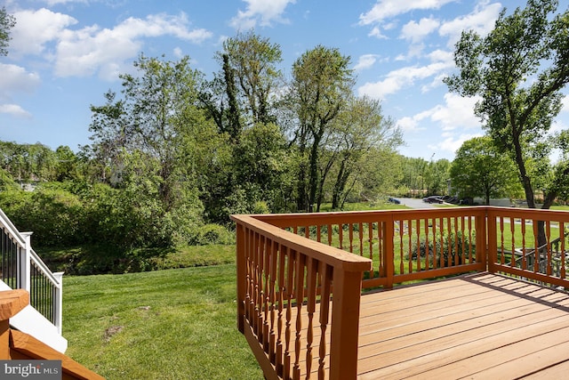 wooden deck with a lawn