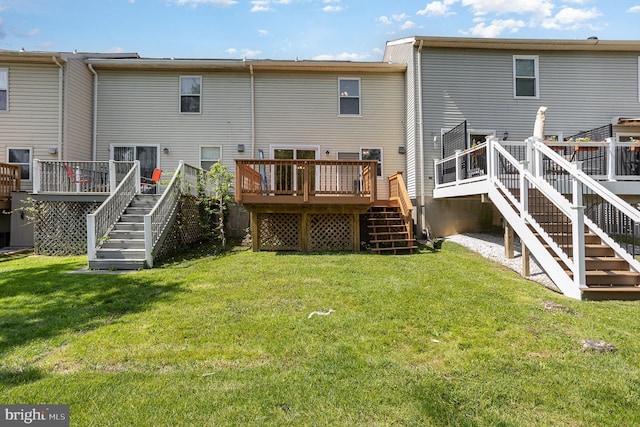 back of house with stairs, a yard, and a deck