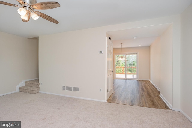 unfurnished room featuring visible vents, carpet flooring, baseboards, and ceiling fan