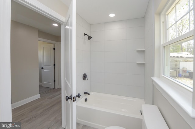 full bathroom with recessed lighting, baseboards, tub / shower combination, and wood finished floors