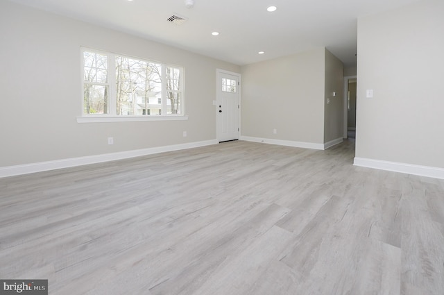 unfurnished living room with visible vents, recessed lighting, a healthy amount of sunlight, and light wood-type flooring