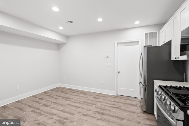 kitchen with light wood-style floors, recessed lighting, white cabinetry, and stainless steel gas range