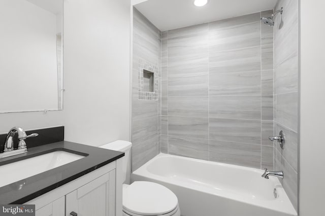 full bath featuring vanity, tub / shower combination, and toilet