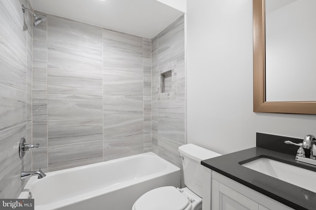 bathroom with vanity, bathtub / shower combination, and toilet