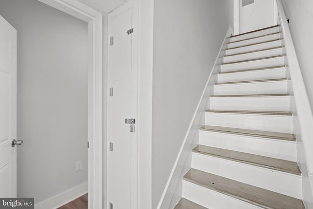 stairs with baseboards and wood finished floors