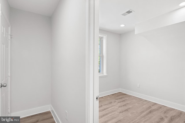 unfurnished room with baseboards, recessed lighting, wood finished floors, and visible vents