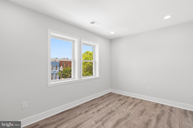 unfurnished room featuring recessed lighting, baseboards, visible vents, and light wood finished floors