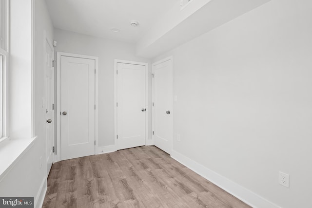 unfurnished bedroom with baseboards and wood finished floors