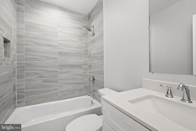 bathroom with vanity, tub / shower combination, and toilet