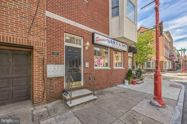 view of exterior entry with brick siding