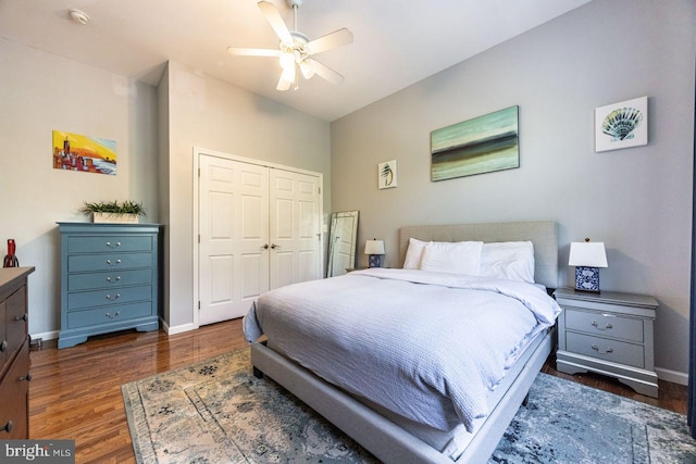 bedroom featuring baseboards, ceiling fan, a closet, and wood finished floors