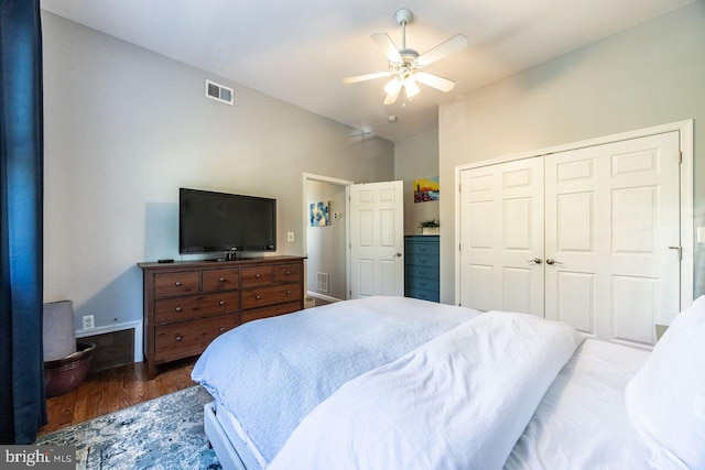 bedroom with visible vents, a closet, wood finished floors, high vaulted ceiling, and a ceiling fan