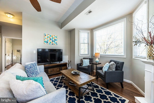 living room with visible vents, a ceiling fan, baseboards, and wood finished floors