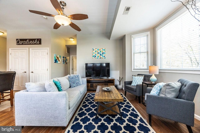 living room featuring a ceiling fan, wood finished floors, and visible vents