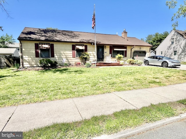 view of front of home featuring a garage, a front lawn, a chimney, and concrete driveway