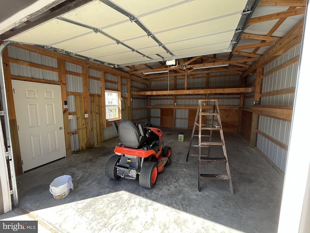 garage featuring metal wall and a garage door opener