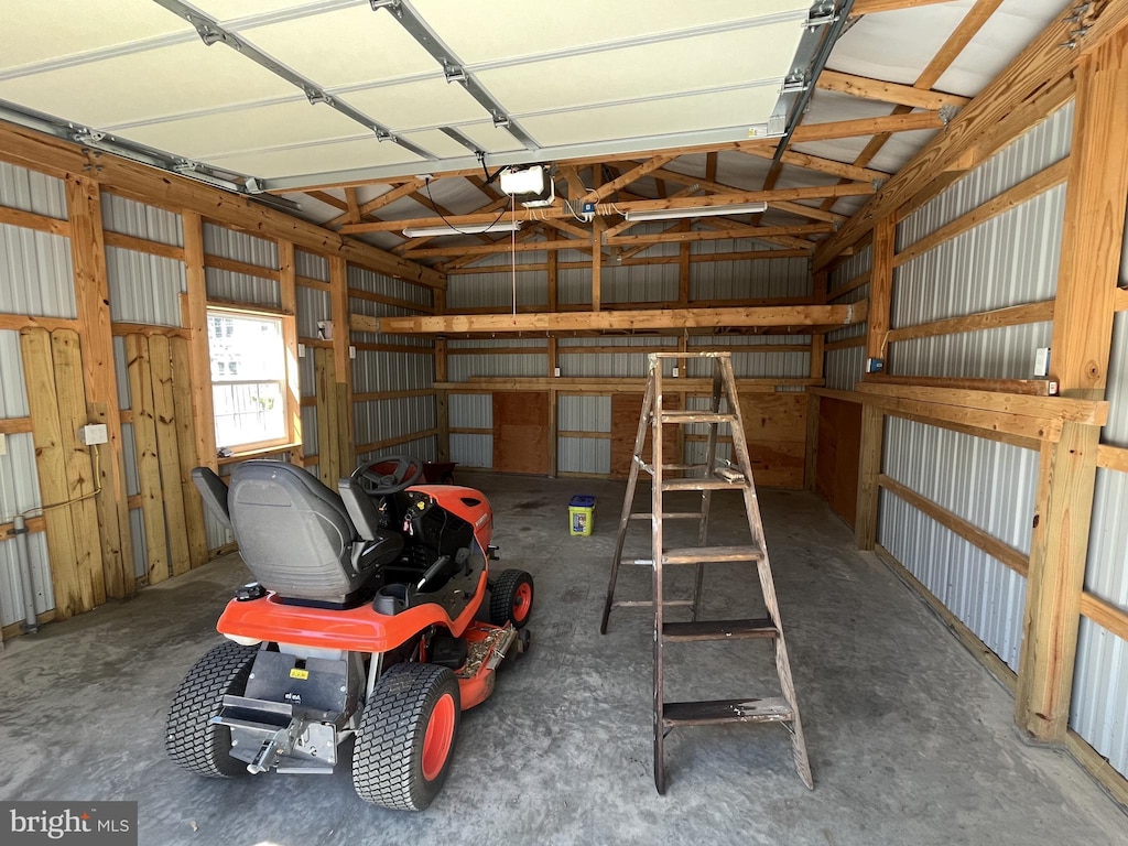 garage with a garage door opener and metal wall