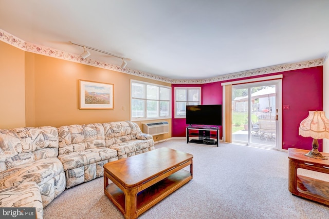 living room featuring carpet floors, plenty of natural light, and rail lighting