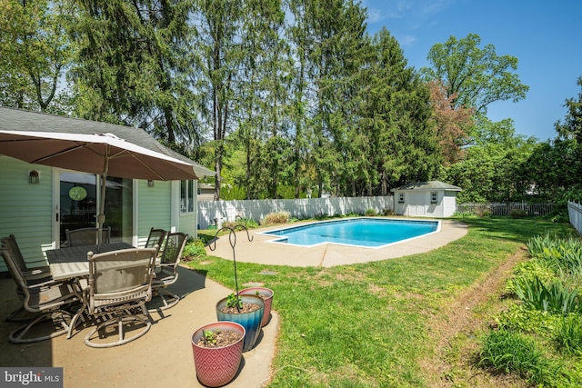 view of pool featuring a patio area, a fenced in pool, an outdoor structure, a fenced backyard, and a yard