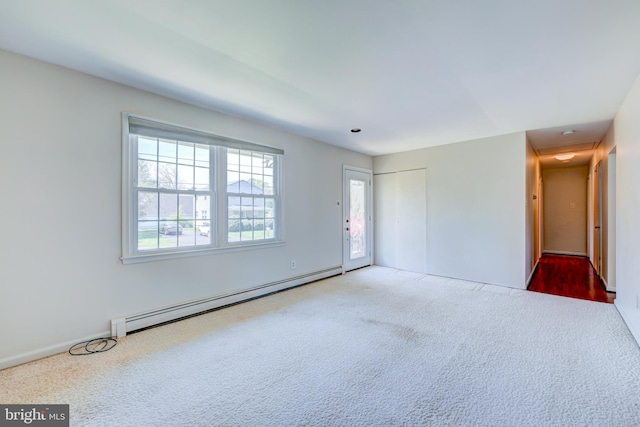 unfurnished room featuring carpet floors, baseboards, and baseboard heating