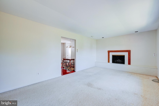 unfurnished living room featuring carpet and a fireplace