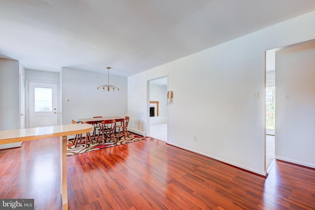 dining area with an inviting chandelier and wood finished floors